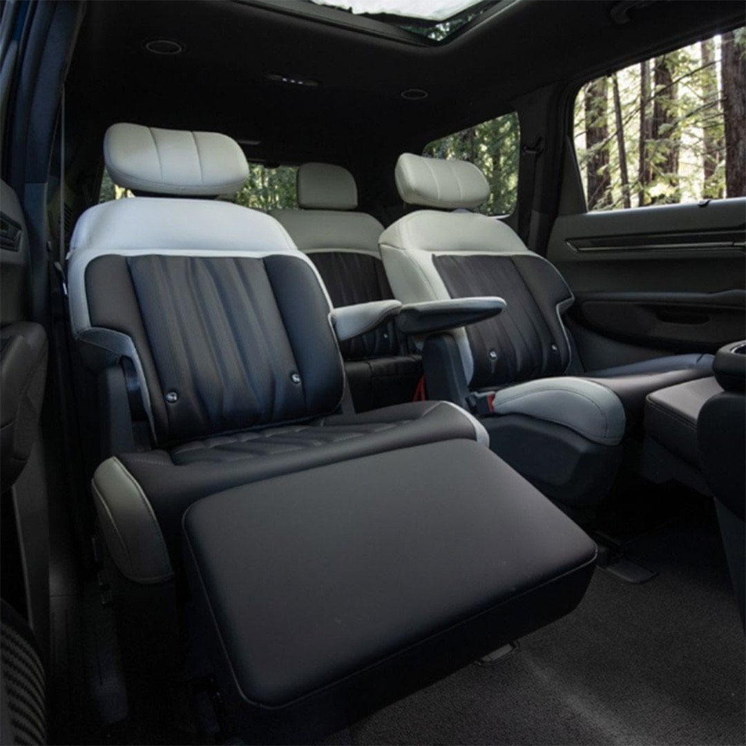 Kia EV9 second-row captain’s chairs reclined with relaxation ottomans extended